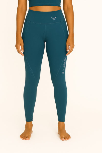 Women's Emerald Green Leggings – Front View with Model Highlighting Waistband, Flat Seams, and Contoured Fit